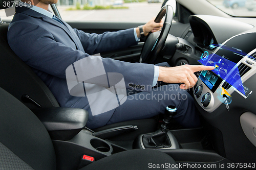 Image of close up of man driving car with navigation