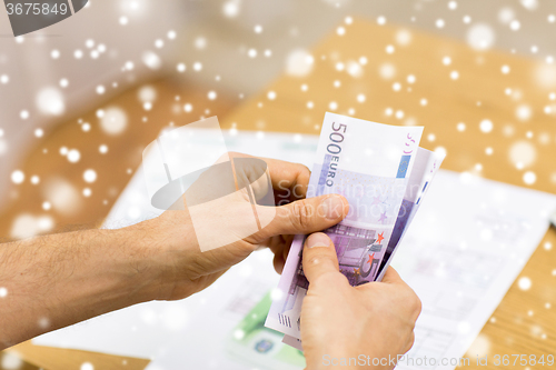 Image of close up of man hands counting money at home