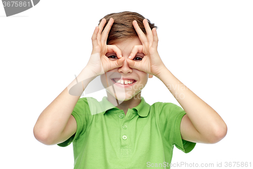 Image of happy boy in t-shirt having fun and making faces