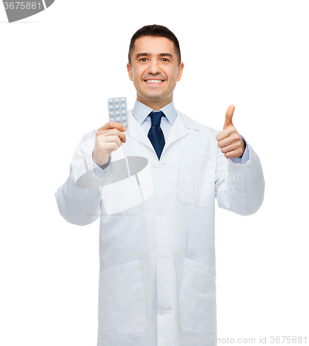 Image of smiling male doctor in white coat with tablets