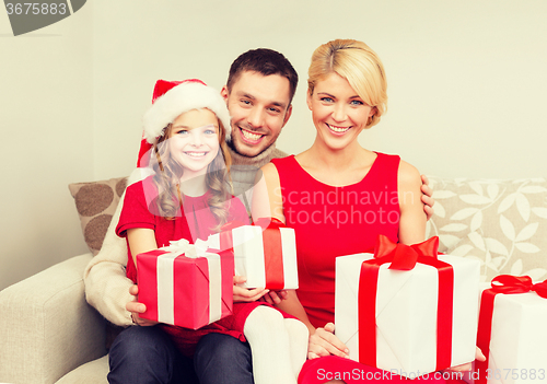 Image of smiling family holding many gift boxes