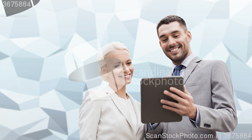 Image of smiling businessmen with tablet pc outdoors