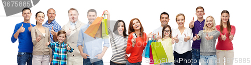 Image of happy people with shopping bags showing thumbs up