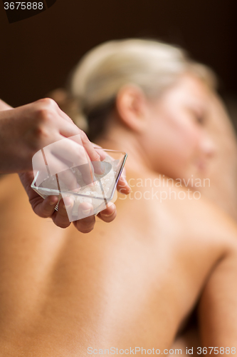 Image of close up of woman having salt massage in spa