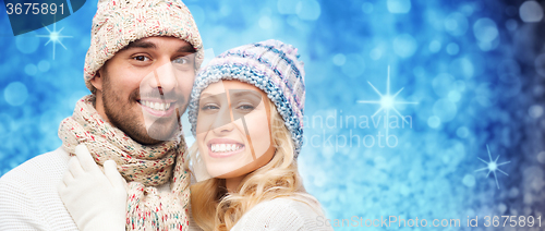 Image of smiling couple in winter clothes hugging