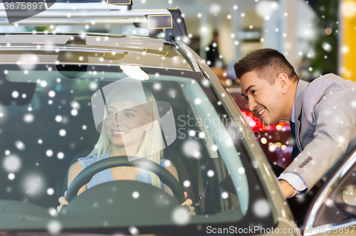 Image of happy woman with car dealer in auto show or salon