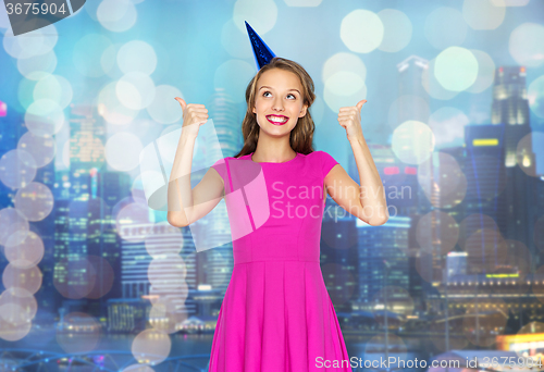 Image of happy young woman or teen girl in party cap