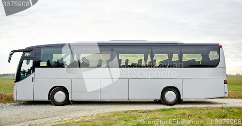 Image of tour bus driving outdoors