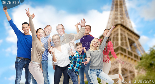 Image of group of happy people having fun over eiffel tower