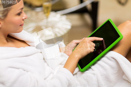 Image of close up of beautiful woman with tablet pc at spa