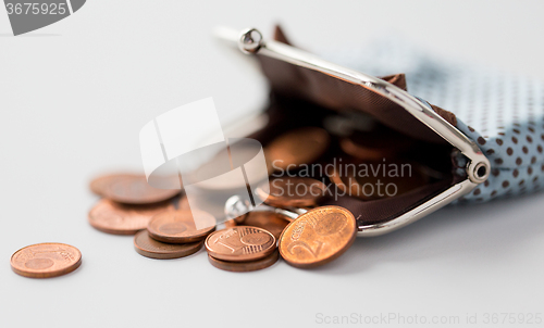 Image of close up of euro coins and wallet on table