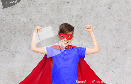 Image of boy in red super hero cape and mask showing fists