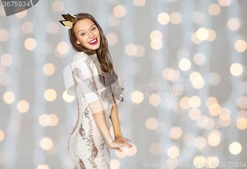 Image of happy young woman or girl in party dress and crown