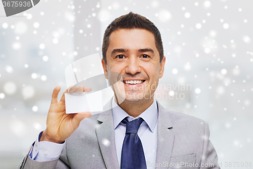 Image of smiling businessman in suit showing visiting card