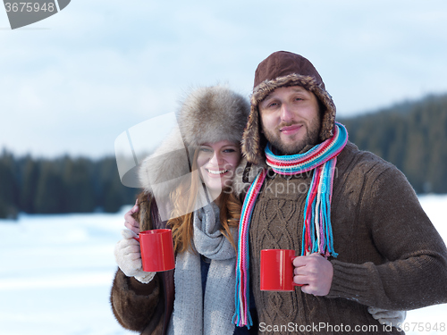 Image of happy young couple drink warm tea at winter