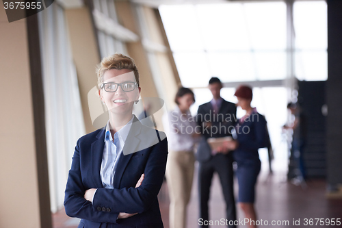 Image of business people group, woman in front  as team leader