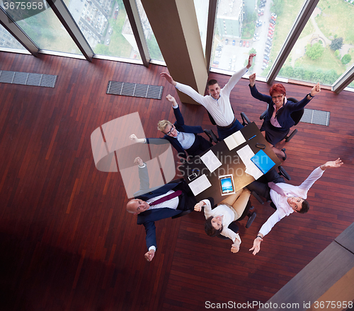 Image of top view of business people group throwing dociments in air