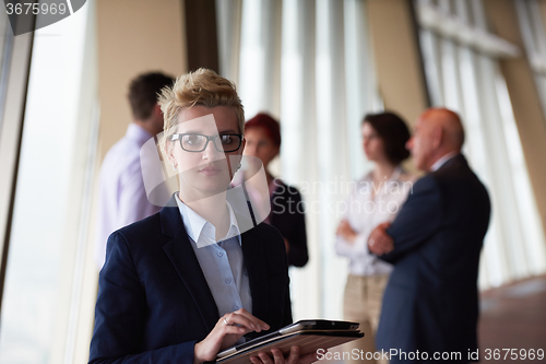 Image of diverse business people group with blonde  woman in front