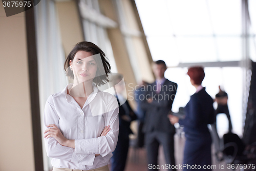 Image of business people group, woman in front  as team leader