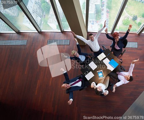 Image of top view of business people group throwing dociments in air