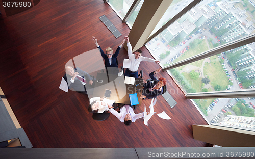 Image of top view of business people group throwing dociments in air