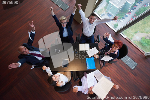 Image of top view of business people group throwing dociments in air