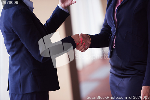 Image of business womans make deal and handshake