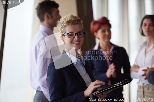 Image of diverse business people group with blonde  woman in front