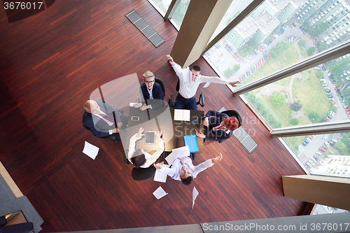 Image of top view of business people group throwing dociments in air