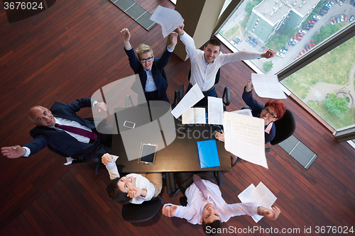 Image of top view of business people group throwing dociments in air