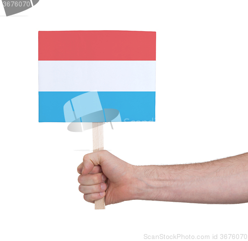 Image of Hand holding small card - Flag of Luxembourg