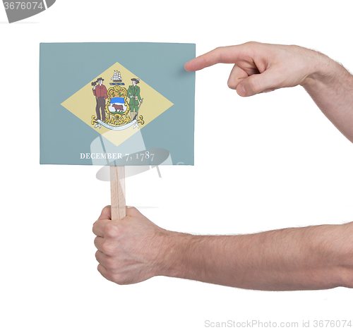 Image of Hand holding small card - Flag of Delaware