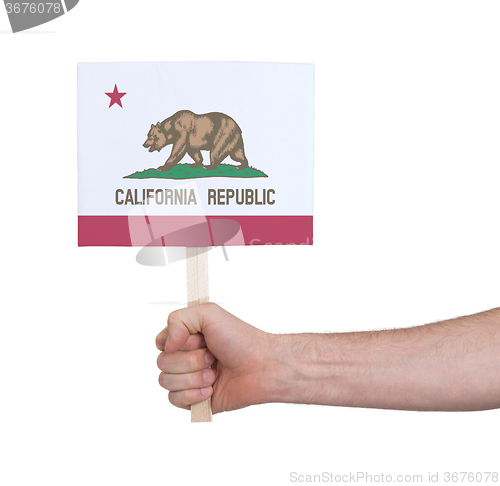 Image of Hand holding small card - Flag of California