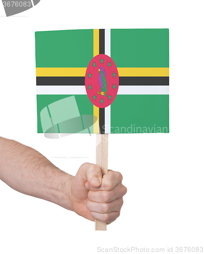 Image of Hand holding small card - Flag of Dominica