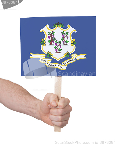 Image of Hand holding small card - Flag of Connecticut