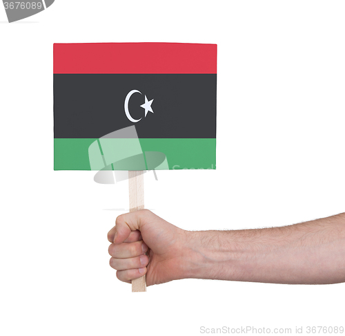 Image of Hand holding small card - Flag of Libya