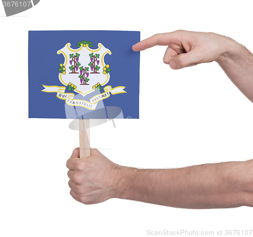 Image of Hand holding small card - Flag of Connecticut