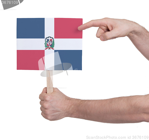 Image of Hand holding small card - Flag of Dominican Republic