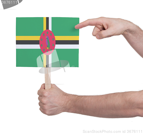Image of Hand holding small card - Flag of Dominica