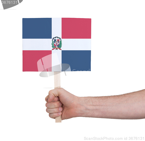 Image of Hand holding small card - Flag of Dominican Republic