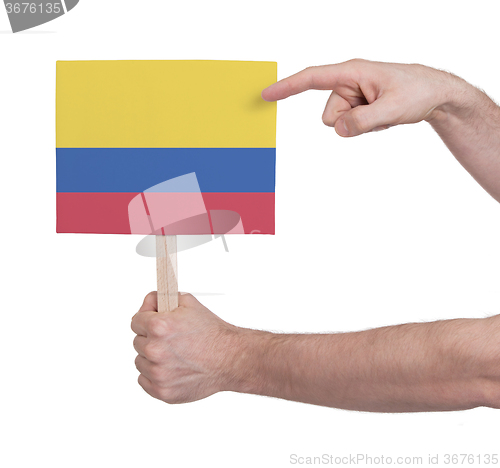 Image of Hand holding small card - Flag of Colombia