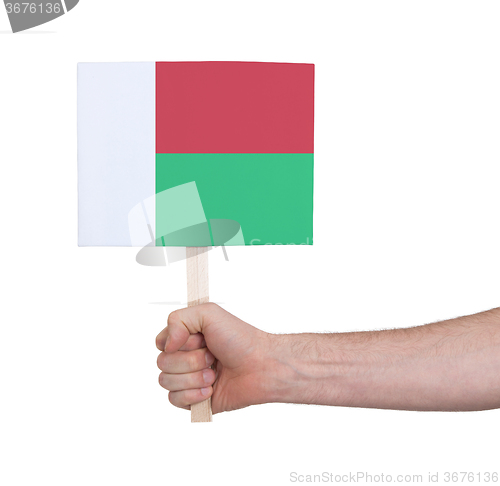 Image of Hand holding small card - Flag of Madagascar