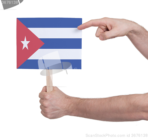 Image of Hand holding small card - Flag of Cuba