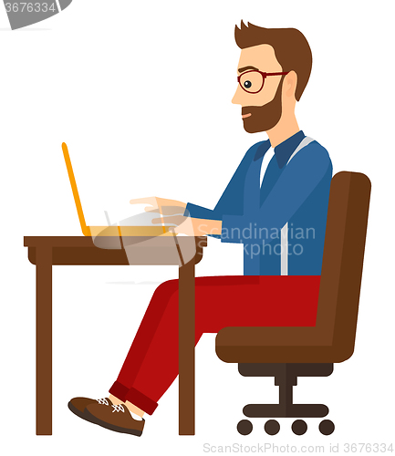 Image of Man working at laptop.