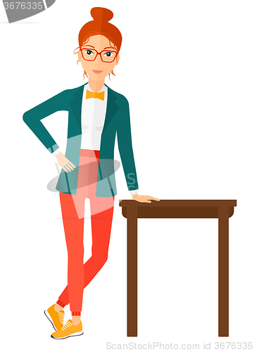 Image of Woman leaning on table.