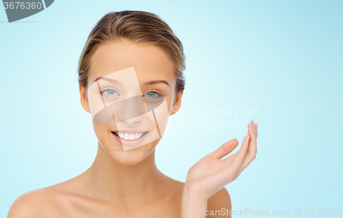 Image of smiling young woman face and shoulders