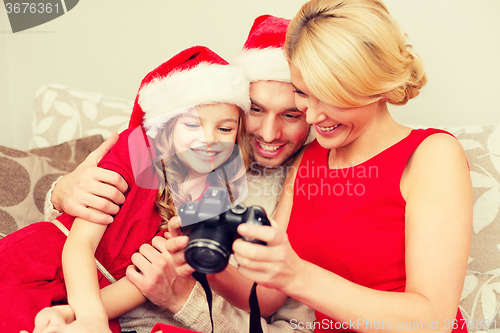 Image of family in santa helper hats looking at pictires