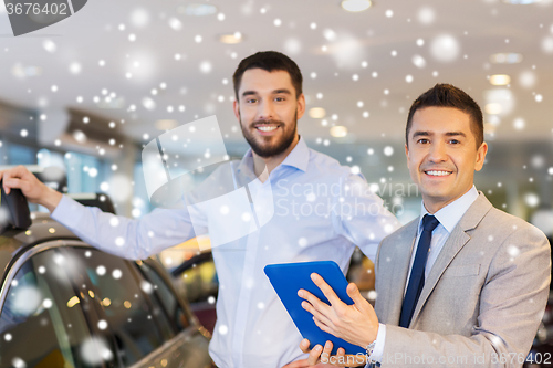 Image of happy man with car dealer in auto show or salon