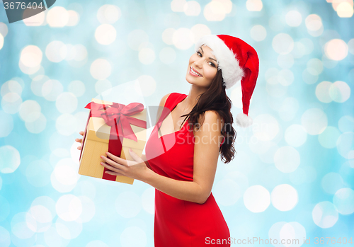 Image of beautiful sexy woman in santa hat with gift box