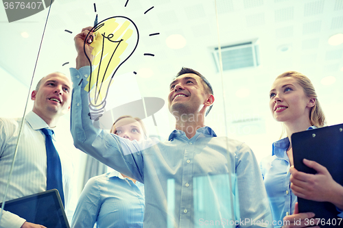 Image of smiling business people with marker and stickers